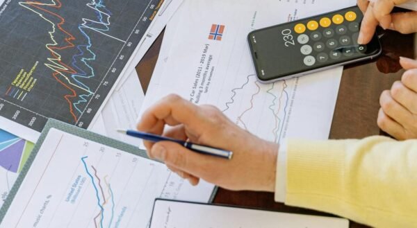 Business professionals analyzing financial charts and graphs during a meeting.